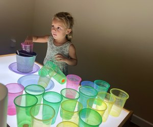 Little girl playing in the light lab at Imaginology Kids