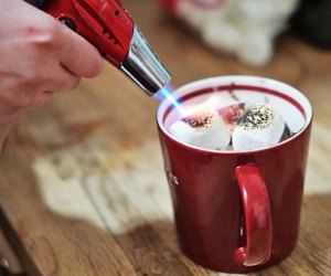 Kitchen torch toasts marshmallows atop at mug cake