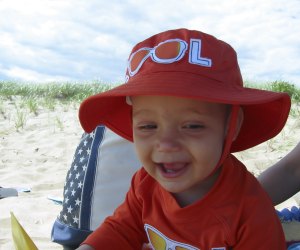 Image of toddler smiling on Cape Cod Beach.