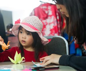 child learning origami
