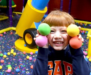 Boy in a ball pit at Laser Bounce, one of our favorite trampoline parks in NYC