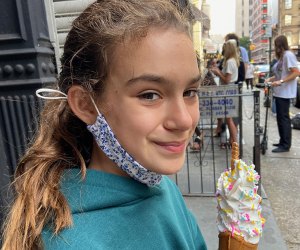Taiyaki NYC. girl eating a unicorn ice cream in a fish shaped cone
