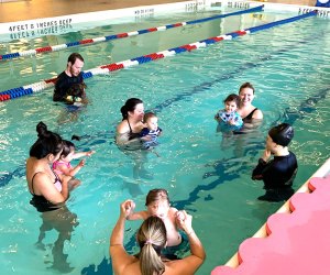 parents and babies in pool swim class