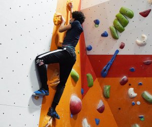 teenager rocking climbing indoors The Cliffs at Harlem