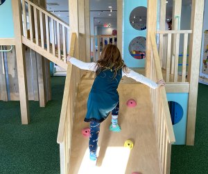 Trendy New Jersey Experiences For Kids: Wild Child Play climbing up an indoor slide