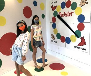 girls posing on giant twister board