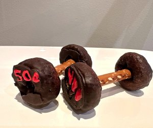 Dumbells made with chocolate covered mini donuts and pretzel sticks.