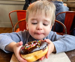 Photo of a child with a donut - Train Rides for Connecticut Kids