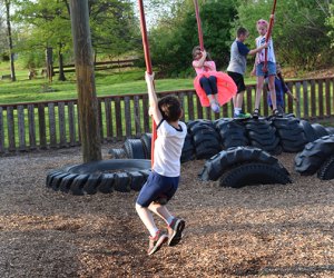 Kids dangle from rope swings at KidStreet