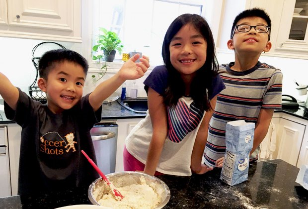 kids at at a counter cooking in the kitchen