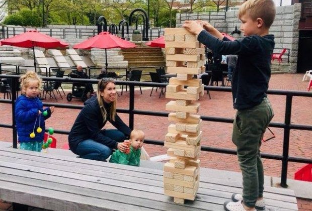 Boston Breweries: Image of family enjoying outdoor space at a Boston beer garden in Charlestown.