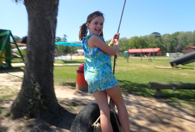 Georgia Peach World Farm girl on a tire swing