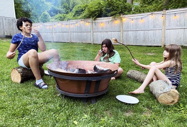 kids around a campfire roasting marshmallows