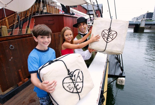 Image of kids throwing tea into Boston Harbor- 100 Things to do in Boston