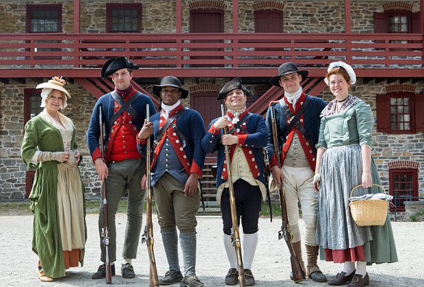 Historical interpreters pose outside The Old Barracks Museum. 