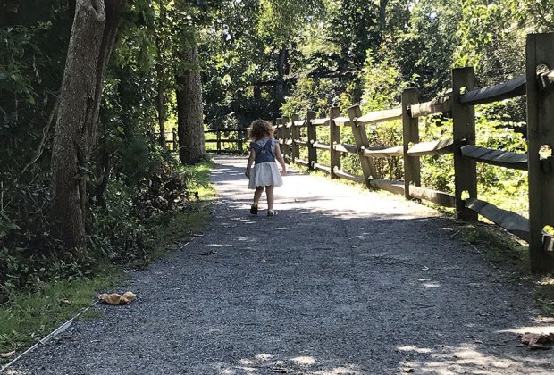 girl on path at path woods in zoo