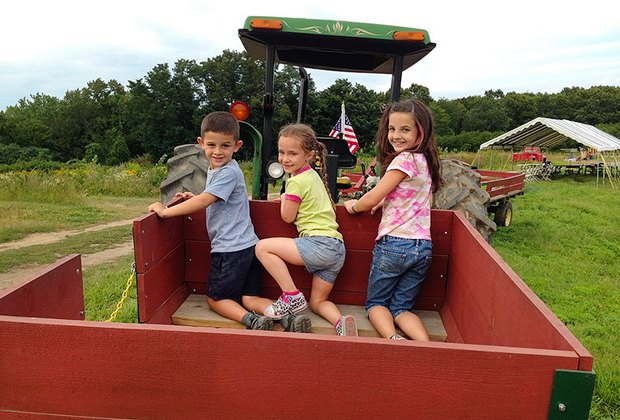 Image of kids playing at an apple orchard near Boston.