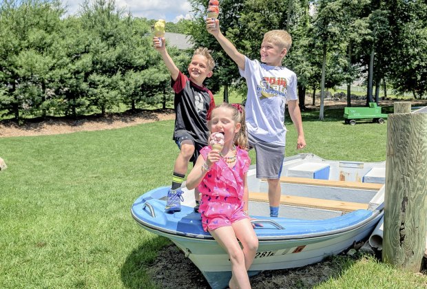 Image of children in a boat holding ice cream cones