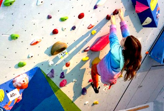 girl indoor rock climbing at Downingtown Rock Gym Indoor Kids' Birthday Party Places Near Philly