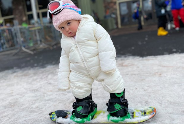 Little girl toddler snowboarding at Hunter Mountain in New York state