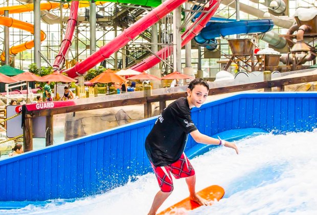 Photo of child on wave pool at indoor water park in VT.