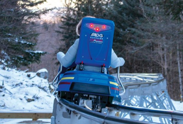 Cliffside Coaster riding down the hill on the coaster Things to Do in Lake Placid on a Winter Vacation Status message