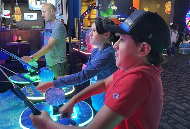 playing arcade games at Dave & Busters Long Island Arcades