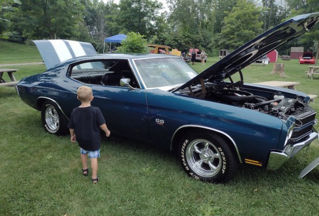 Little boy looks at a classic car at DuBois Farms