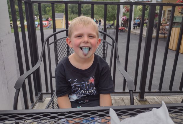 Boy sticks out his tongue at DuBois Farms