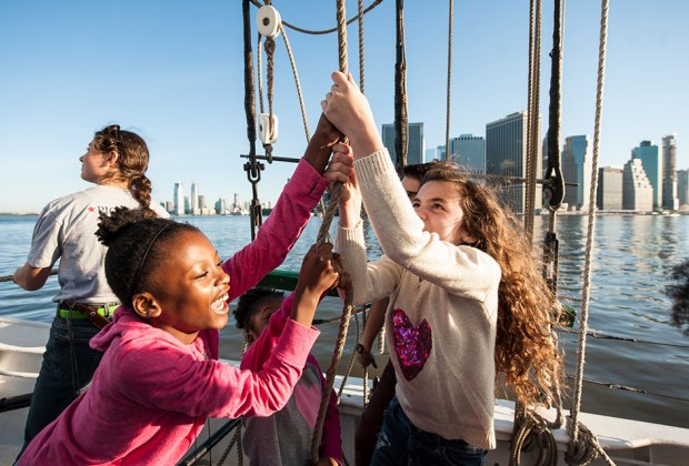 NYC boat ride with kids raising the sail on a schooner