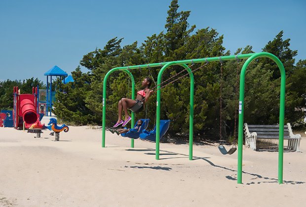 Kids play on a brach playground