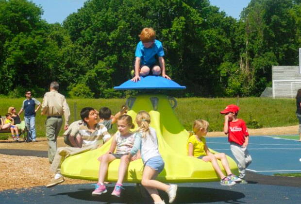 Photo of kids on a merry-go-round at Pease Place playground in CT.