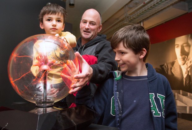 Photo of family with exhibit at MIT Museum.