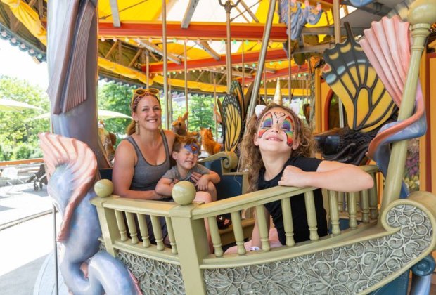 Photo of family on carousel on Boston Greenway.