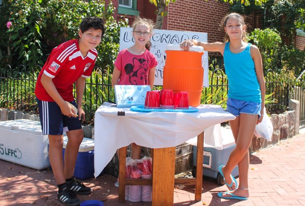 Kids selling lemonade at a lemonade stand