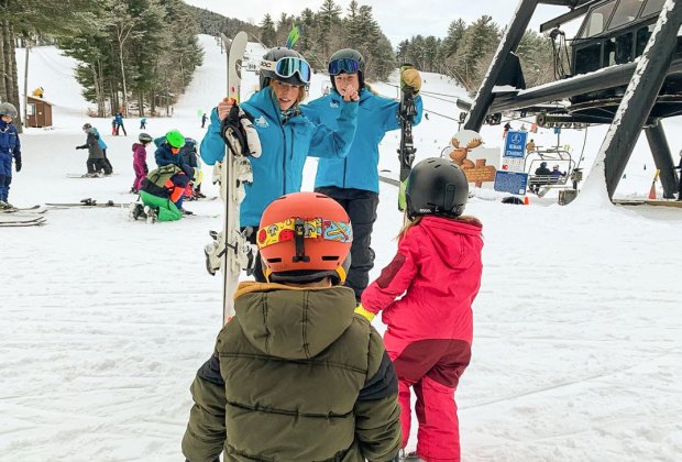 Photo of family near chair lift at a New England ski resort.