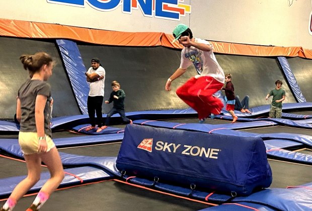 kids of all ages jump and try tricks at sky zone trampoline park