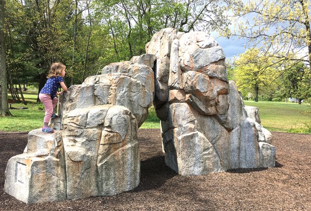 Girl climbs rock formation at Watchung Reservation