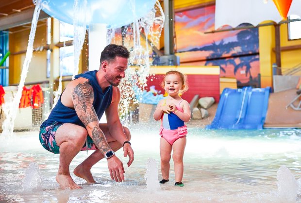 Photo of adult and child at indoor splash pad - Best Indoor Water park.