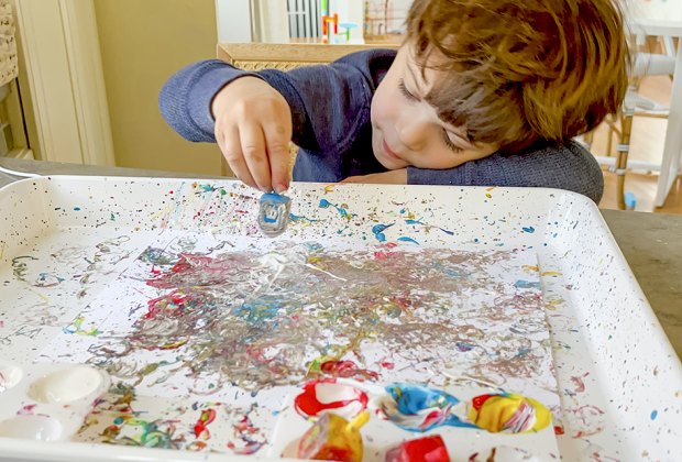 Dip a dreidel in some paint and spin it to create a beautiful piece of art. 