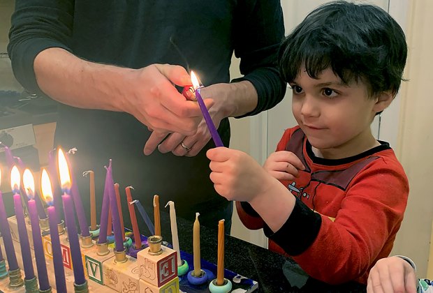 The lighting of the menorah candles is an important job for kids! 