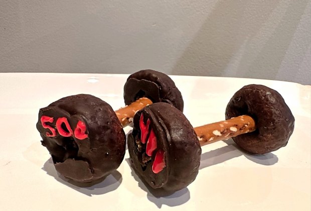 Dumbells made with chocolate covered mini donuts and pretzel sticks.