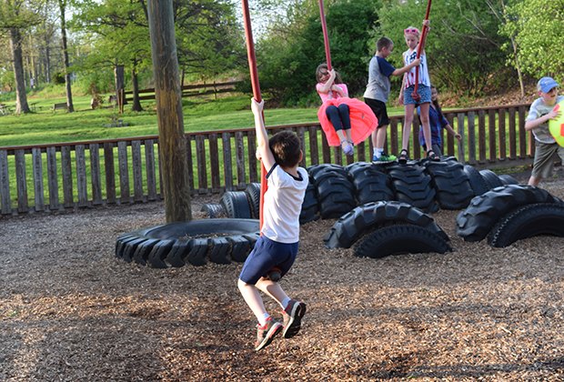 Kids dangle from rope swings at KidStreet