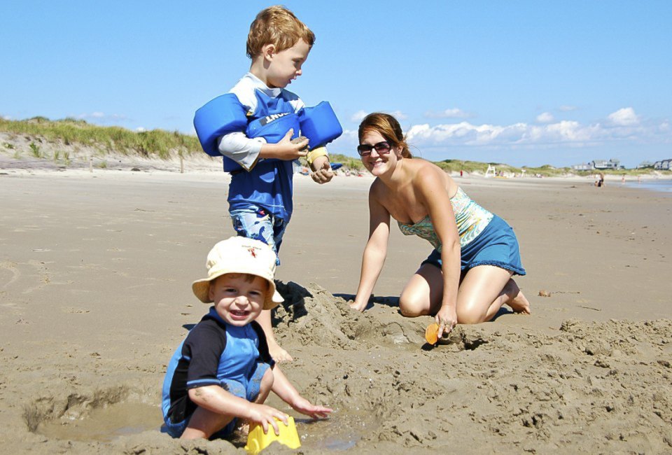 Photo of family on the beach - Things to do in Narragansett with Kids.