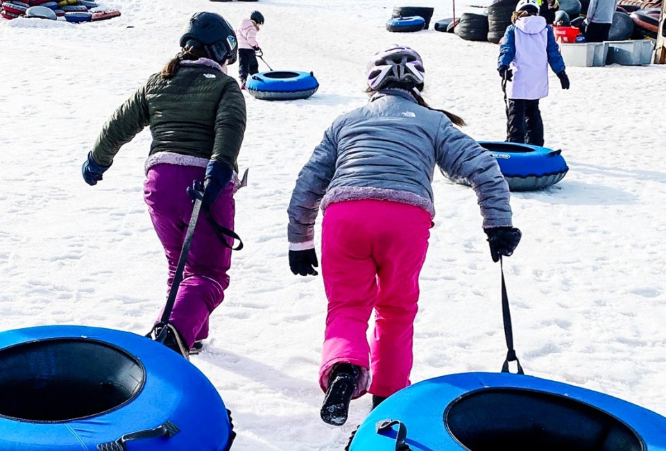 Get those snow pants ready for the best snow tubing in Connecticut for families! Photo by Ally Noel for Mommy Poppins