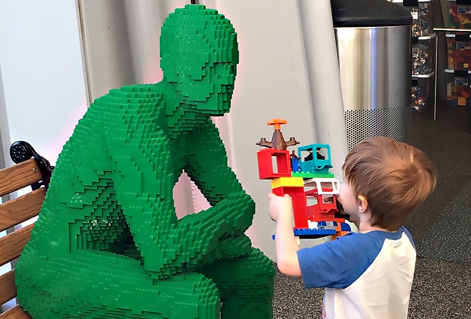 Green and blue brick men preside over the play stations at The Art of the Brick.