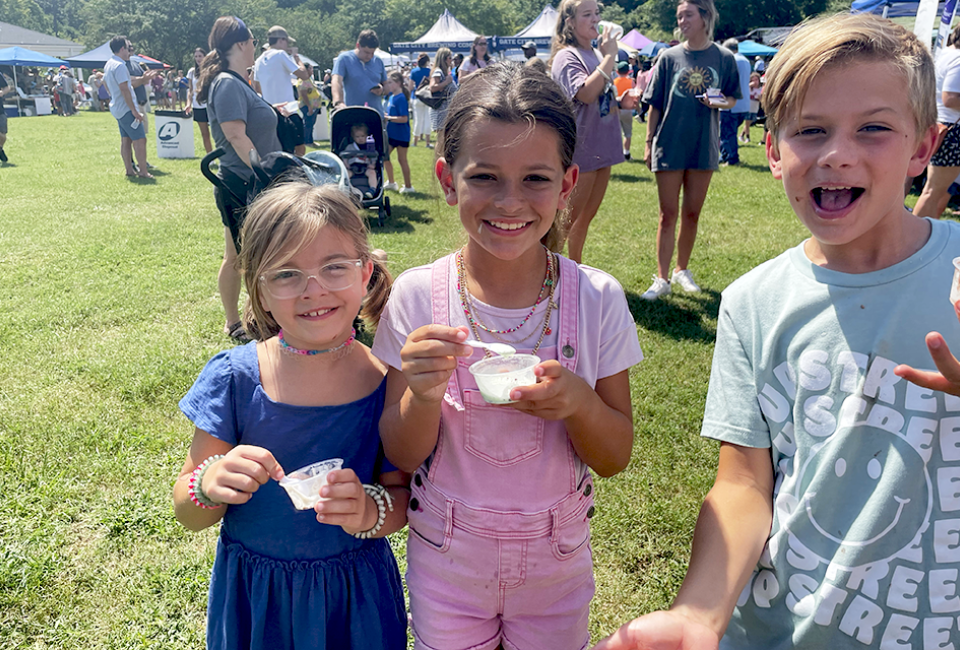 Families sample tons of ice cream flavors, all for a great cause! Visitors to the 20th Annual Miss Mary's Ice Cream Crankin' are treated to locally churned ice cream flavors plus some fun giveaways.  Photo by the author