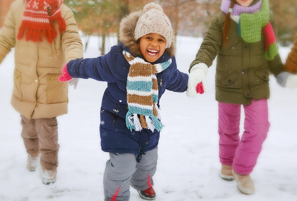 Playing in the snow is a favorite thing to do for kids in Boston during winter. Photo via Bigstock