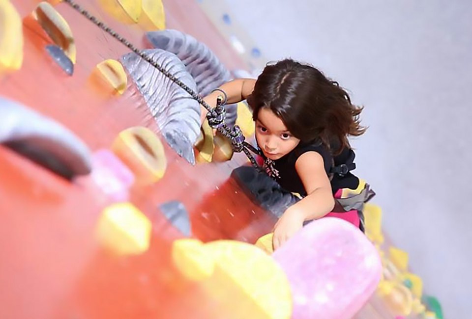 The climbing wall at the Brooklyn Bouldering Project challenges kids to climb to new heights. Photo courtesy of the venue