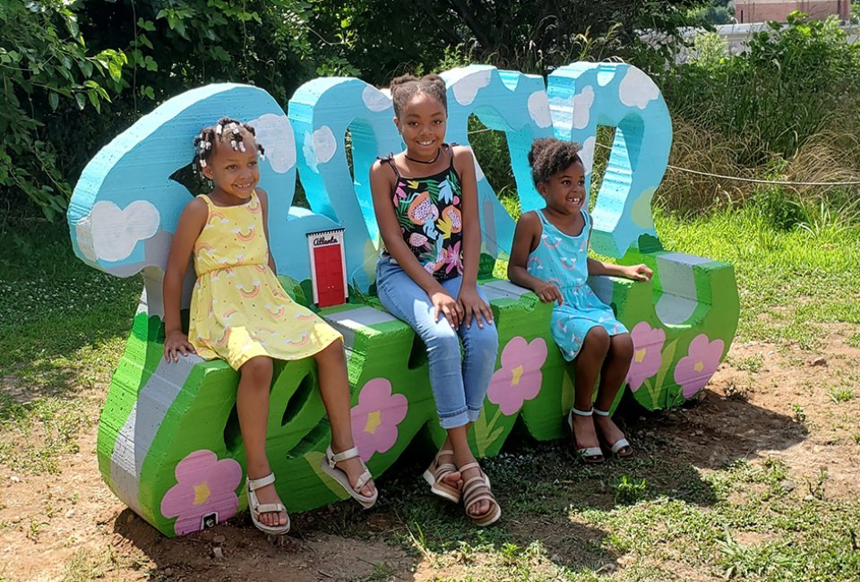 Take a photo at Tiny Doors ATL's door #6, featured in a custom bench by artist Ira Hill, located on the Beltline Eastside trail. Photo courtesy of Tiny Doors ATL